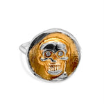 Gold and silver skull pendant on a white background