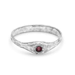 pink sapphire and silver ring on white background
