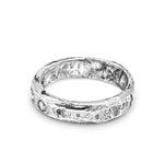 Silver ring with a textured band on a white background