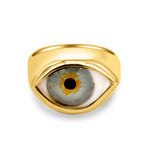 Gold ring with an eye design on a white background