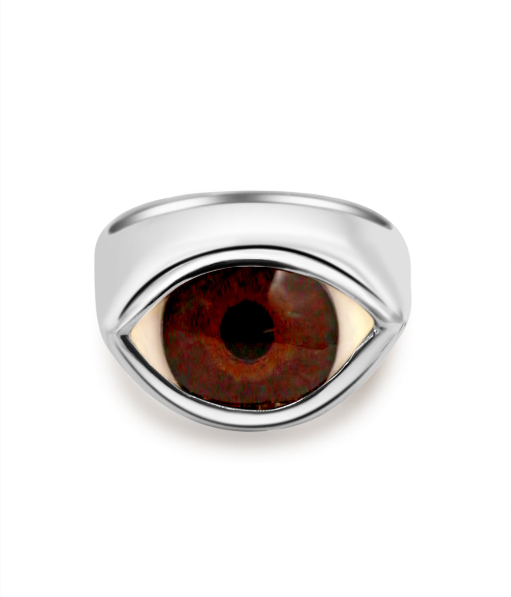 Silver ring with a brown eye-shaped stone on a white background