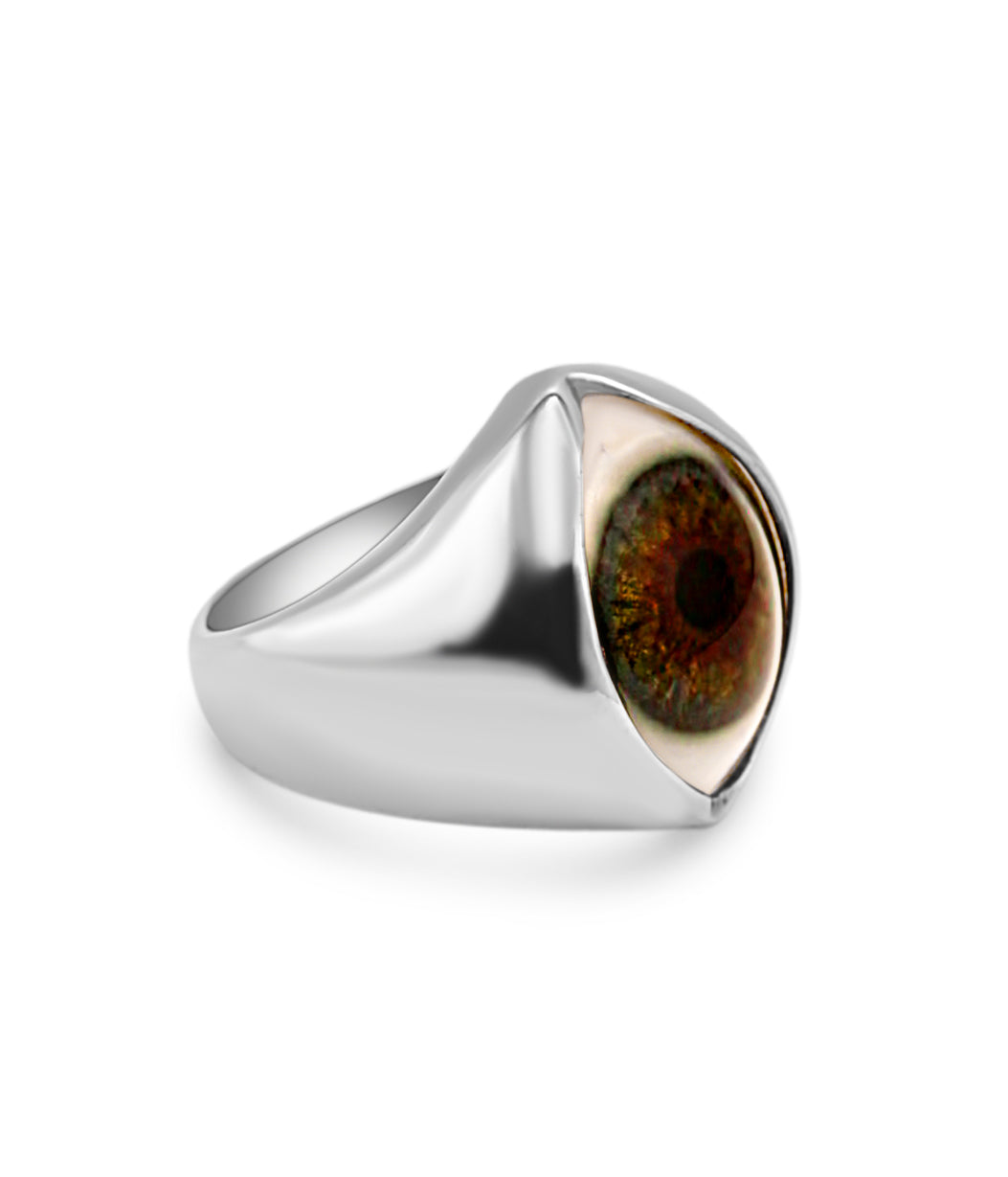 Silver ring with a central eye design on a white background