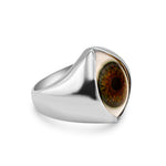 Silver ring with a central eye design on a white background