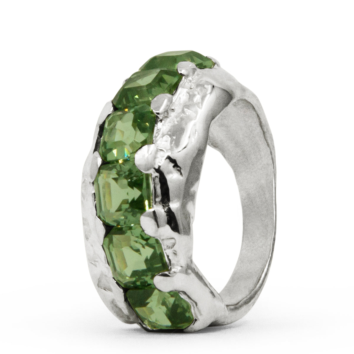 Silver ring with green gemstones on a white background