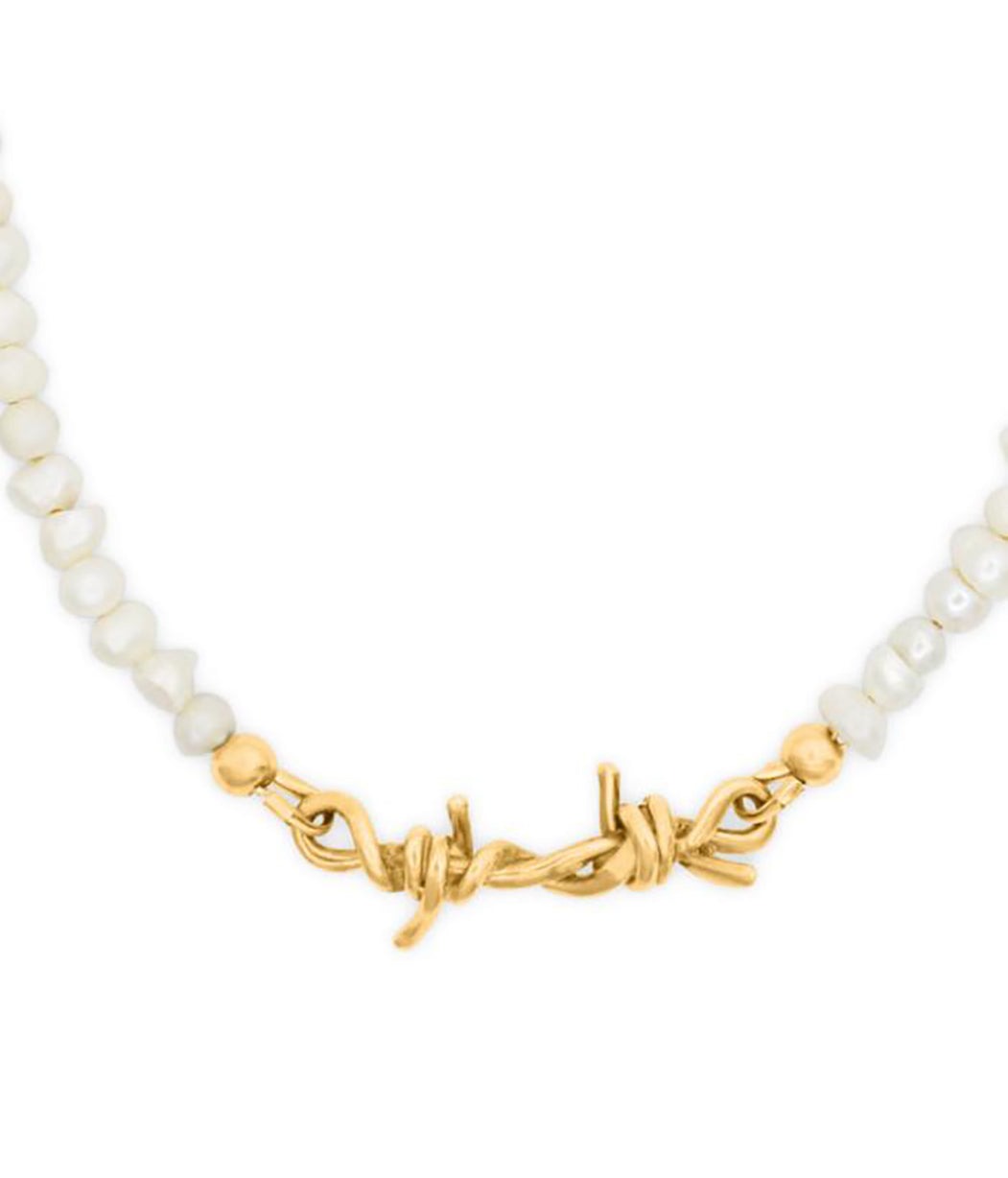 Necklace with white beads and a gold barbwire clasp on a white background