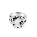 Silver ring with a textured surface on a white background