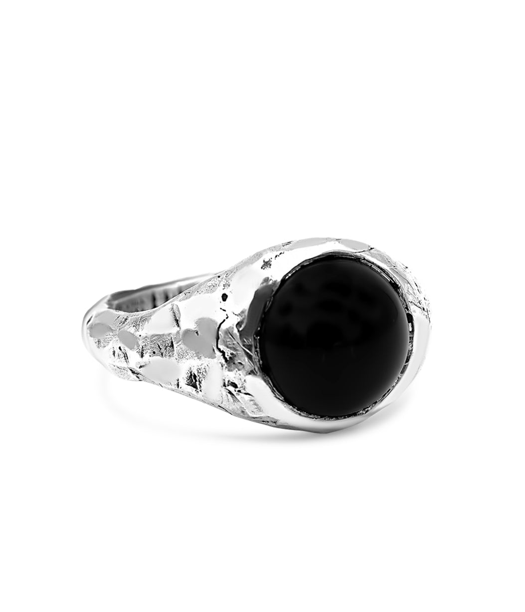 Silver ring with a black stone on a white background