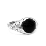 Silver ring with a black stone on a white background