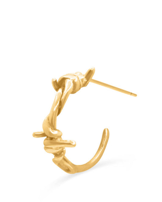 Gold hoop earring on a white background