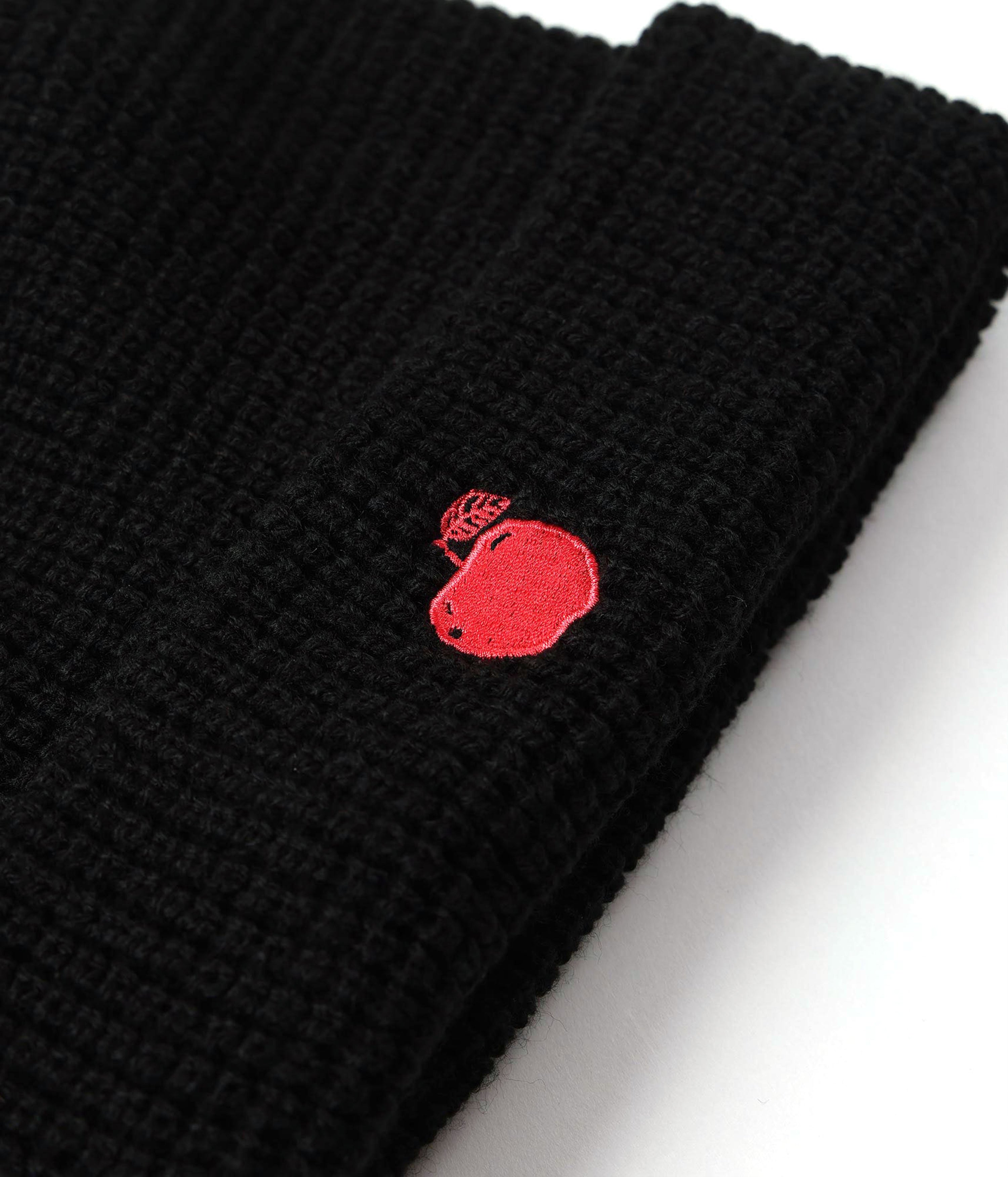 Black knit beanie with a red embroidered logo on a white background