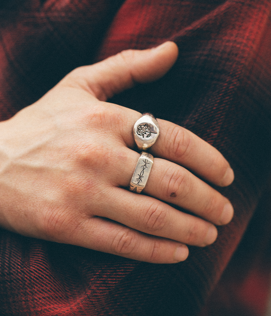 chunky silver rings on a hand