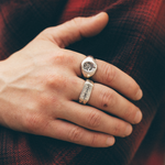 chunky silver rings on a hand