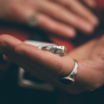 side of a silver ring with a dagger engraving