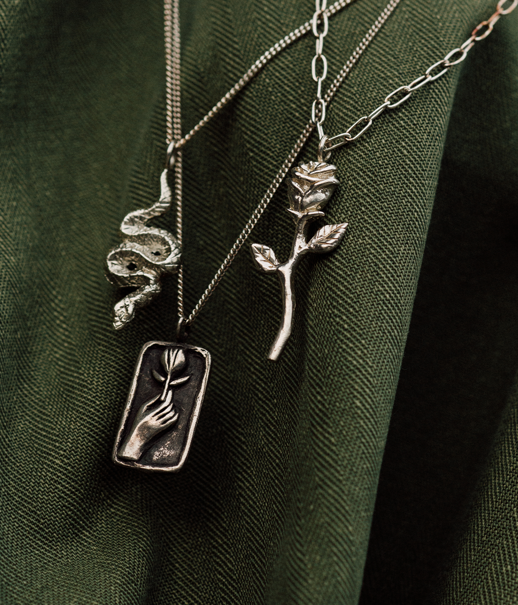 2 silver chains on green jacket