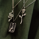 2 silver chains on green jacket