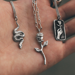 three silver chains in hand 