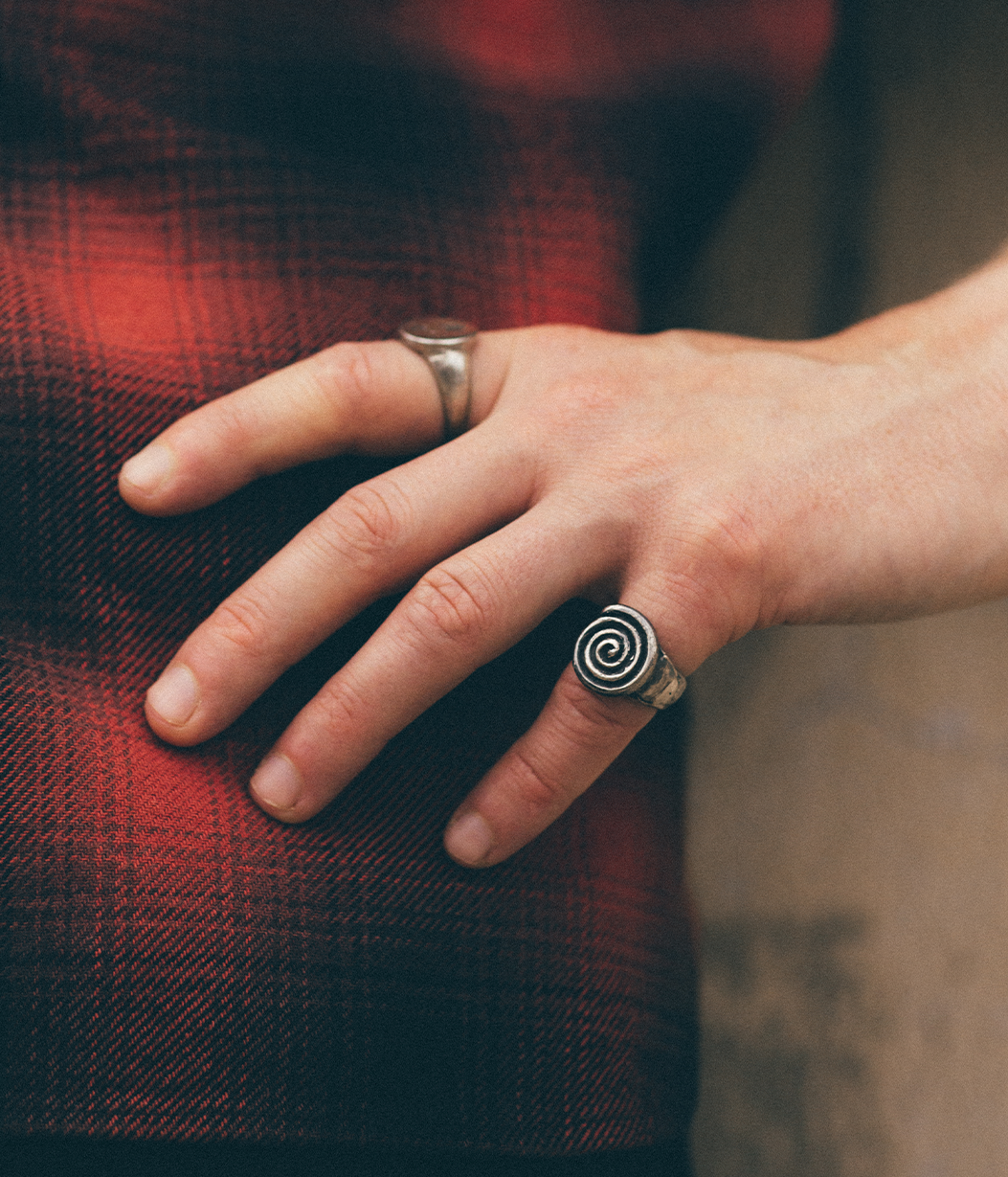 silver spiral ring on pinky finger