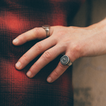 silver spiral ring on pinky finger
