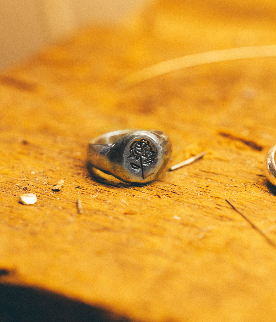 silver ring on wood workbench