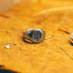 silver ring on wood workbench