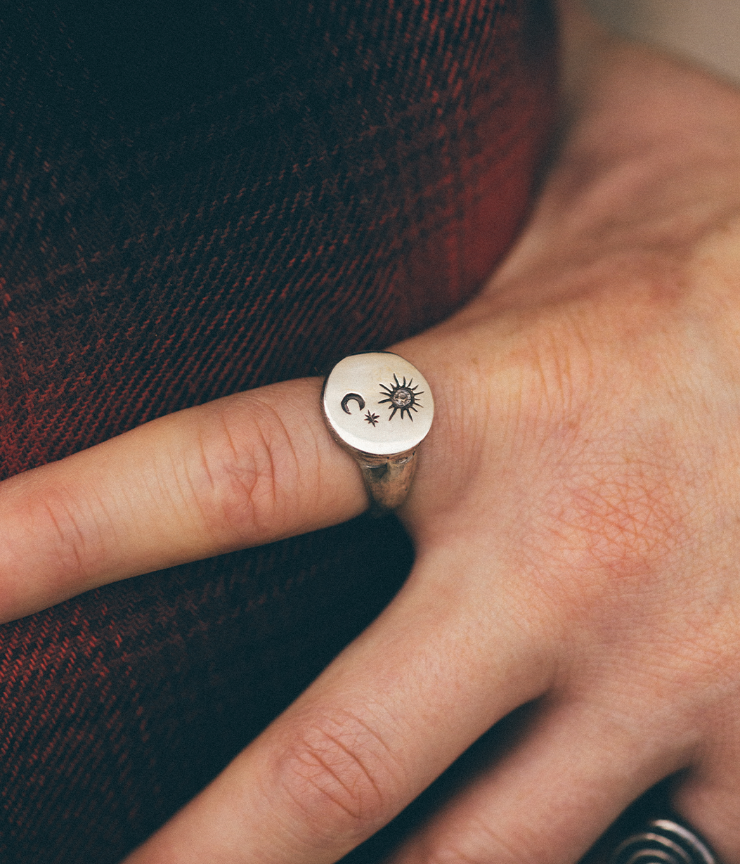 silver star and moon signet ring on hand