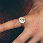 silver star and moon signet ring on hand