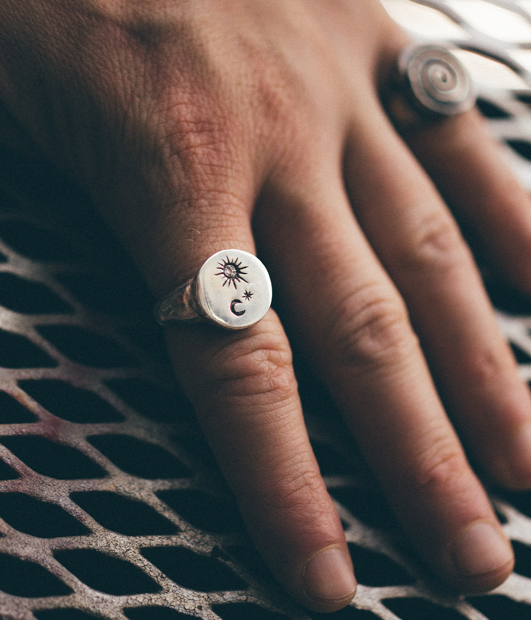 silver star and moon signet ring on hand