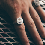 silver star and moon signet ring on hand