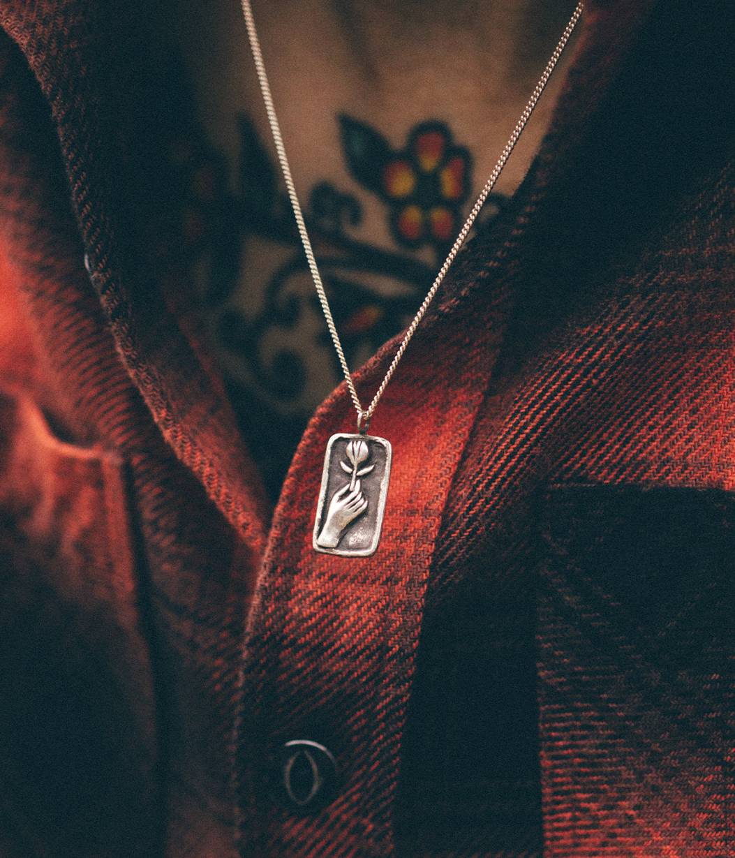 silver rose relief pendant necklace on model