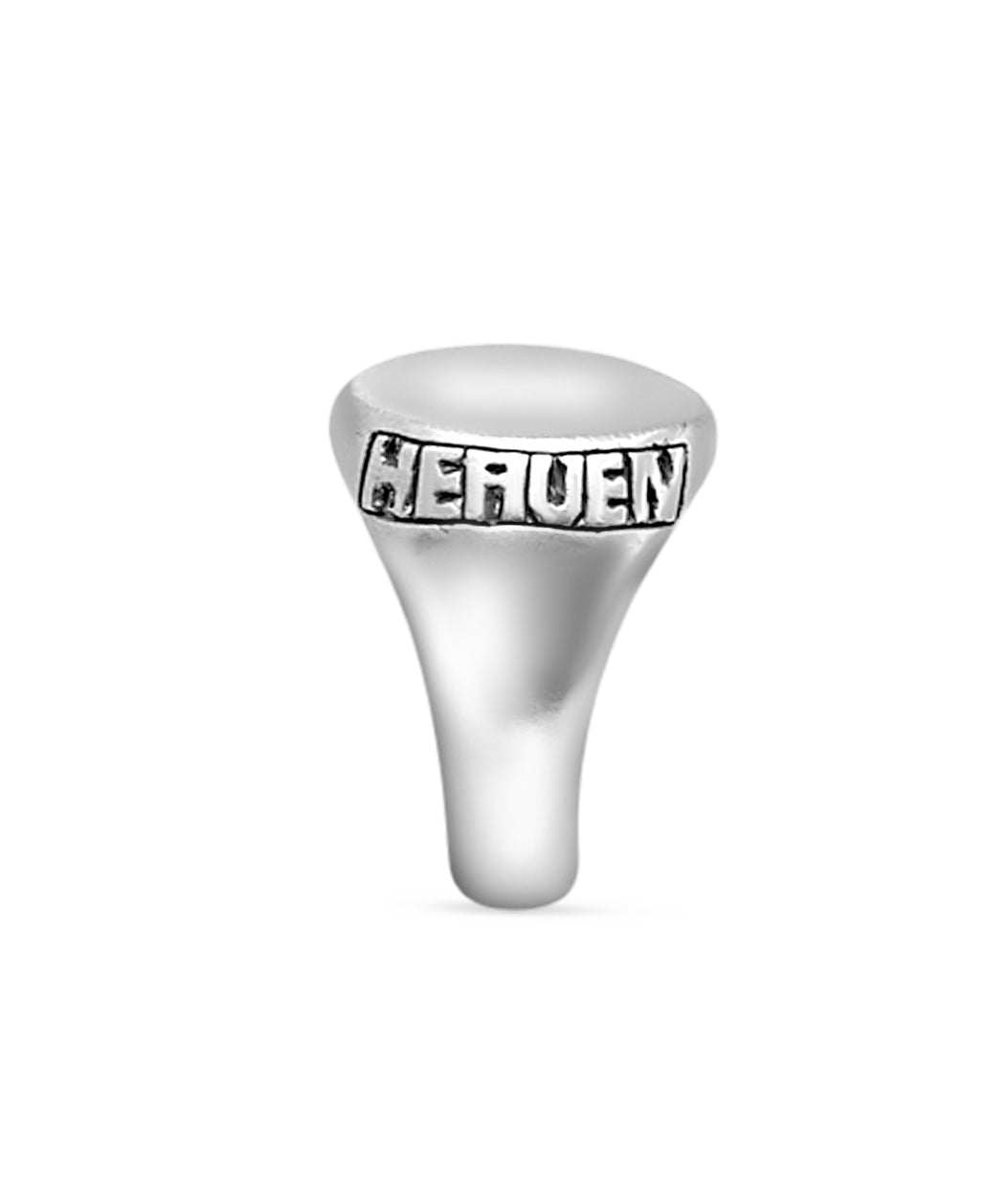 Silver ring with 'HEAVEN' engraving on a white background