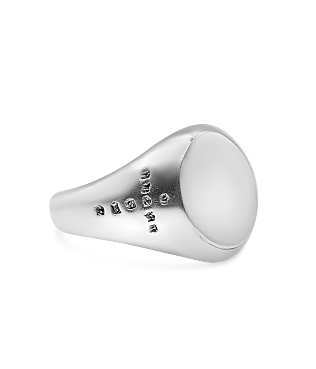 Silver ring with engraved text on a white background