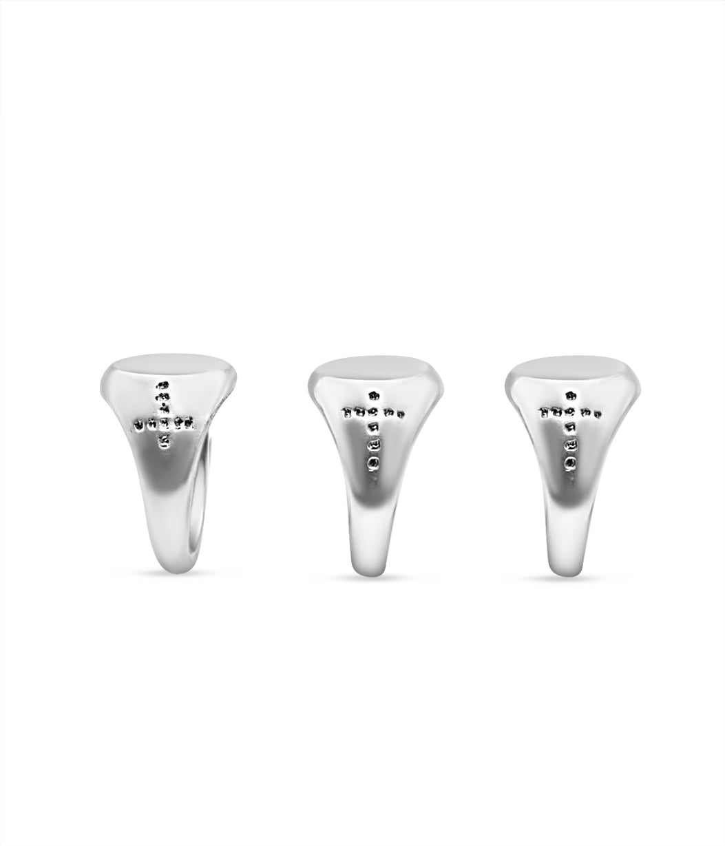 Three silver golf club tees with engraved text on a white background