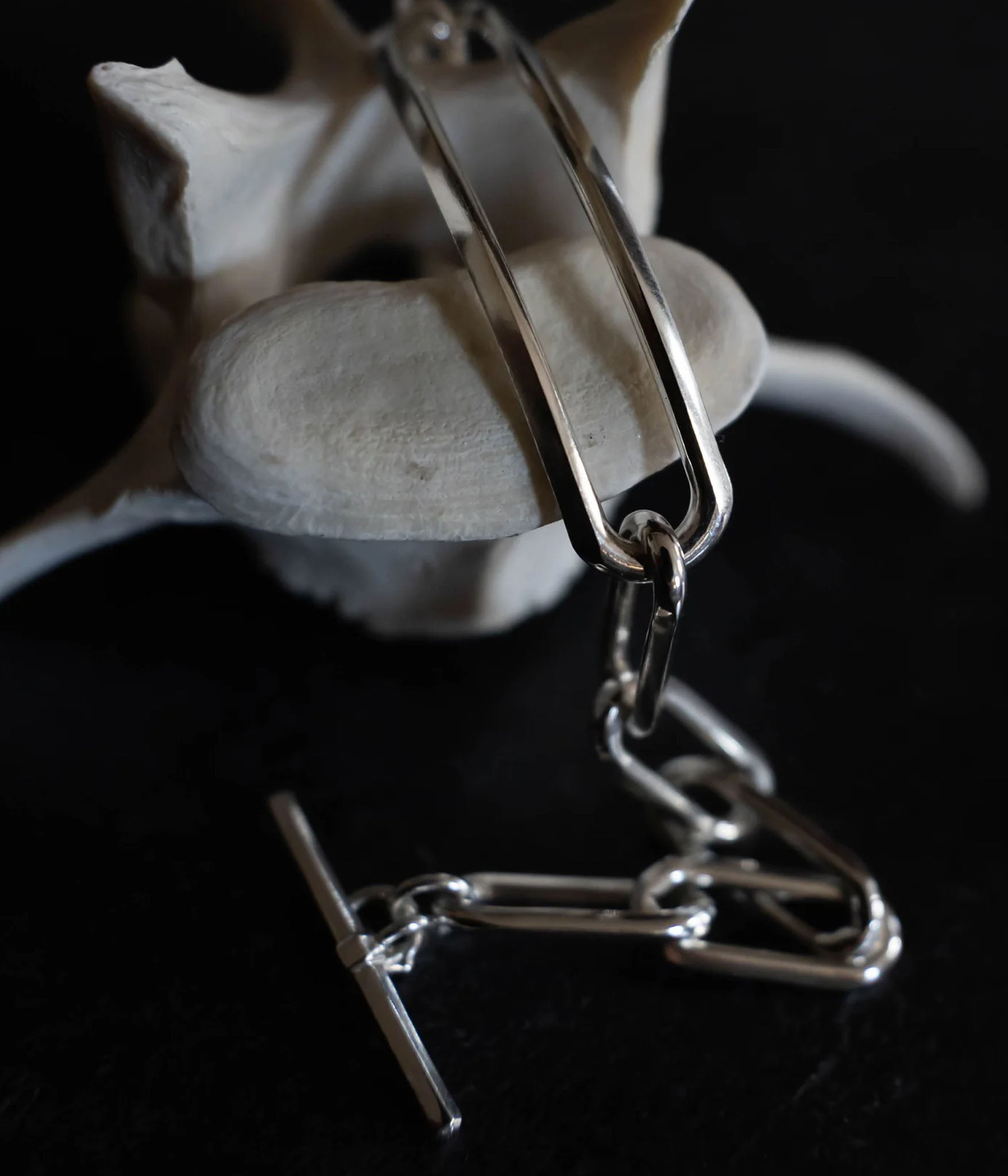 Knife edged chain bracelet with a toggle clasp on dark background 