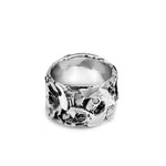 Silver ring with a textured design on a white background