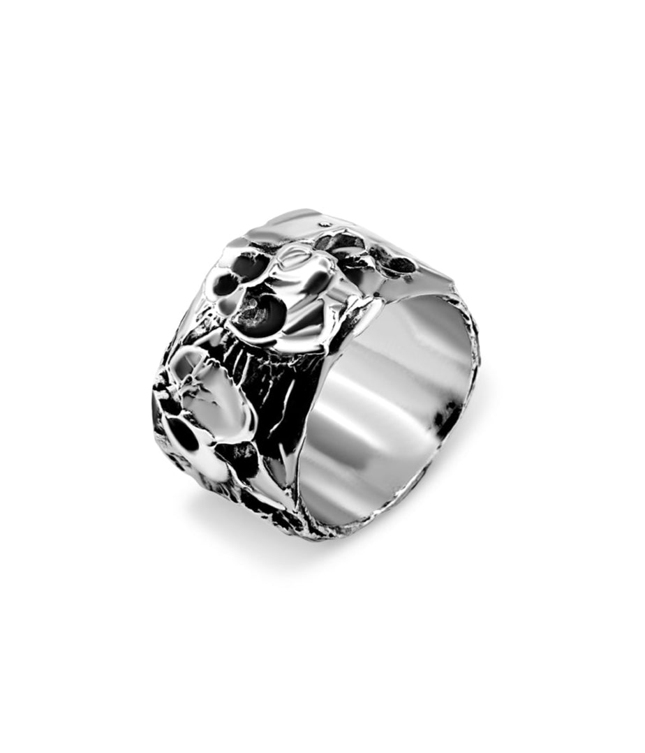 Silver ring with intricate design on a white background