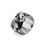 Silver ring with intricate design on a white background