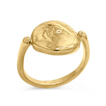 Gold ring with a textured design on a white background