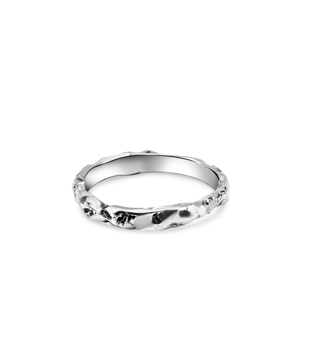 Silver ring with a subtle design on a white background