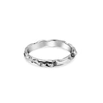 Silver ring with a textured band on a white background