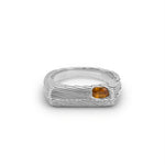 Silver ring with a small orange gemstone on a white background