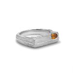 Silver ring with a small orange gemstone on a white background