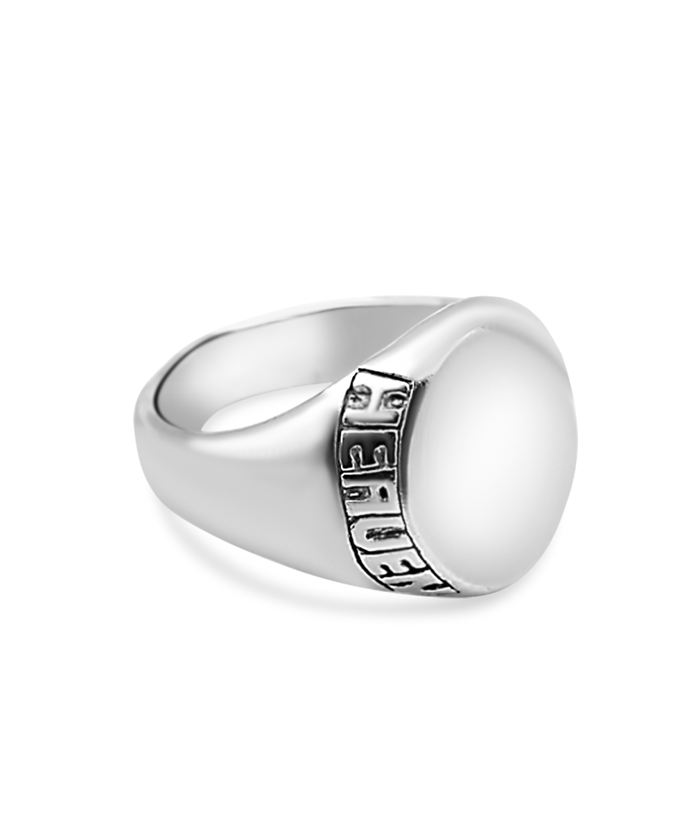 Silver ring with engraved text on a white background