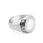 Silver ring with engraved text on a white background