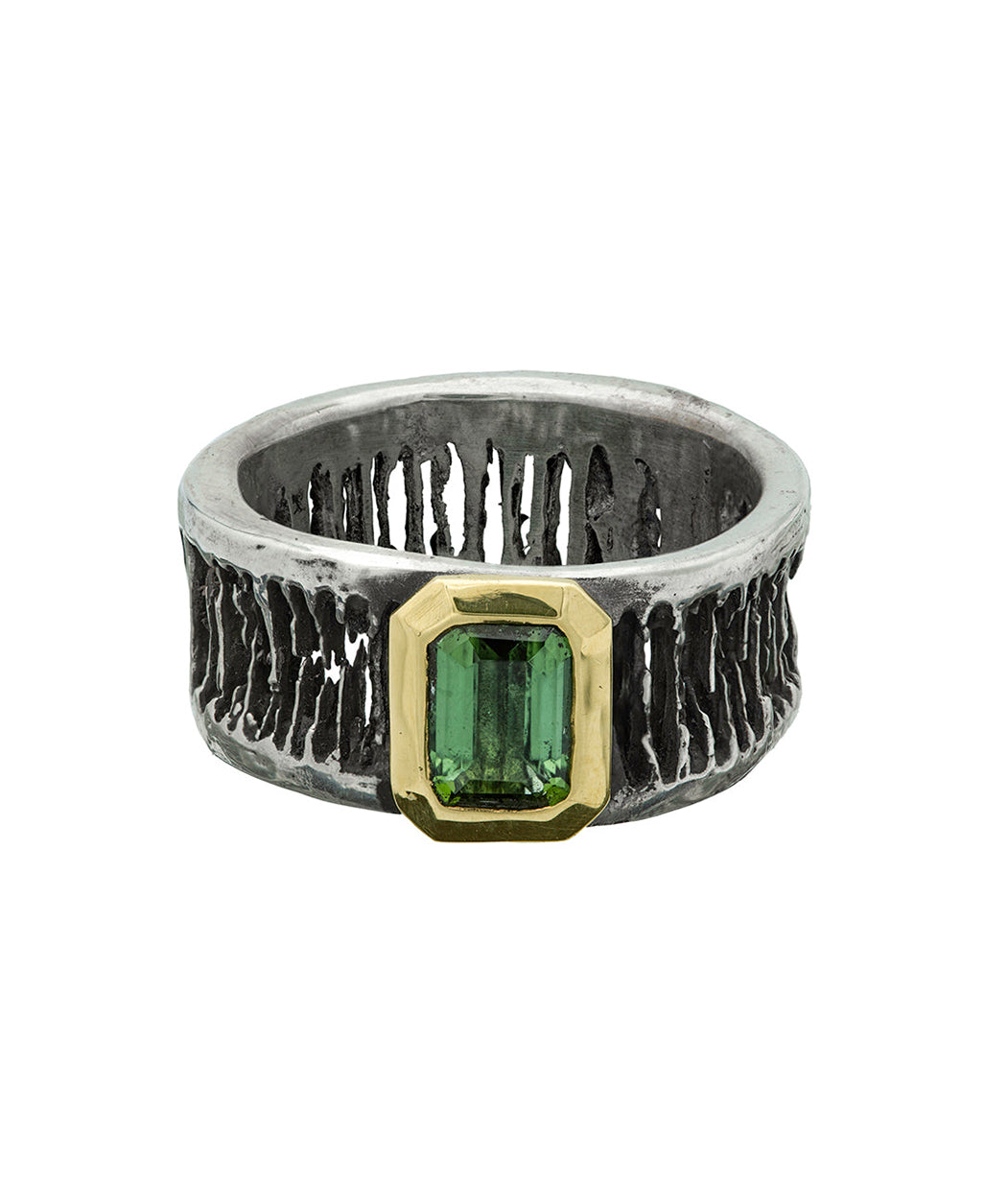 Silver ring with a green gemstone on a white background