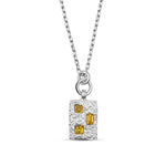 Silver pendant with yellow gemstones on a white background