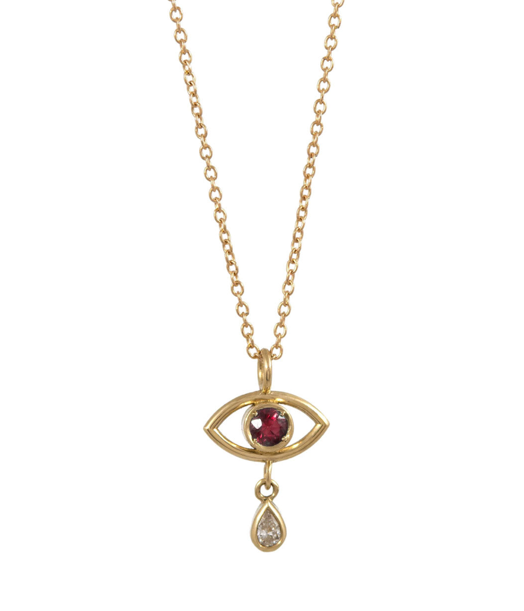 Gold necklace with eye-shaped pendant featuring a red gemstone and a small diamond on a white background