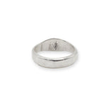 Silver ring with engraved design on a white background