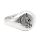 Silver ring with a clown face design on a white background