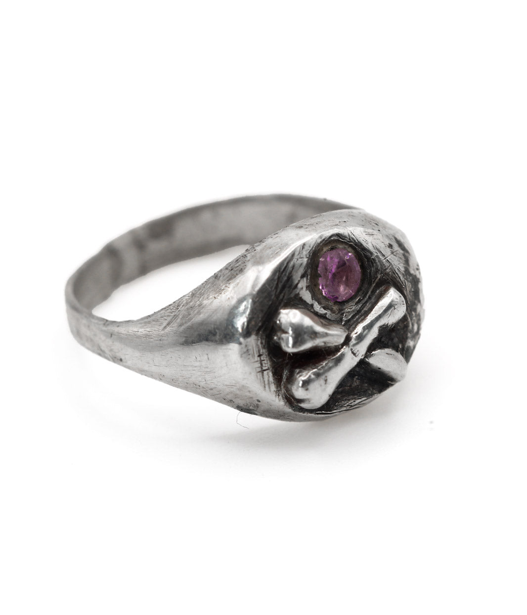 Silver ring with a purple gemstone on a white background