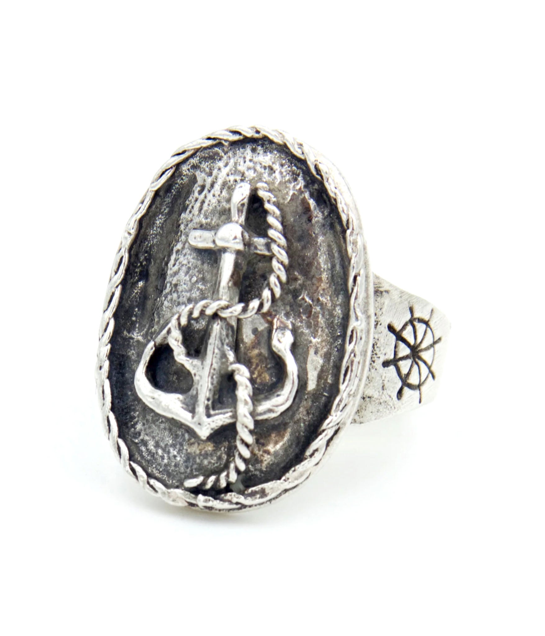 Silver ring with anchor and cross design on a white background
